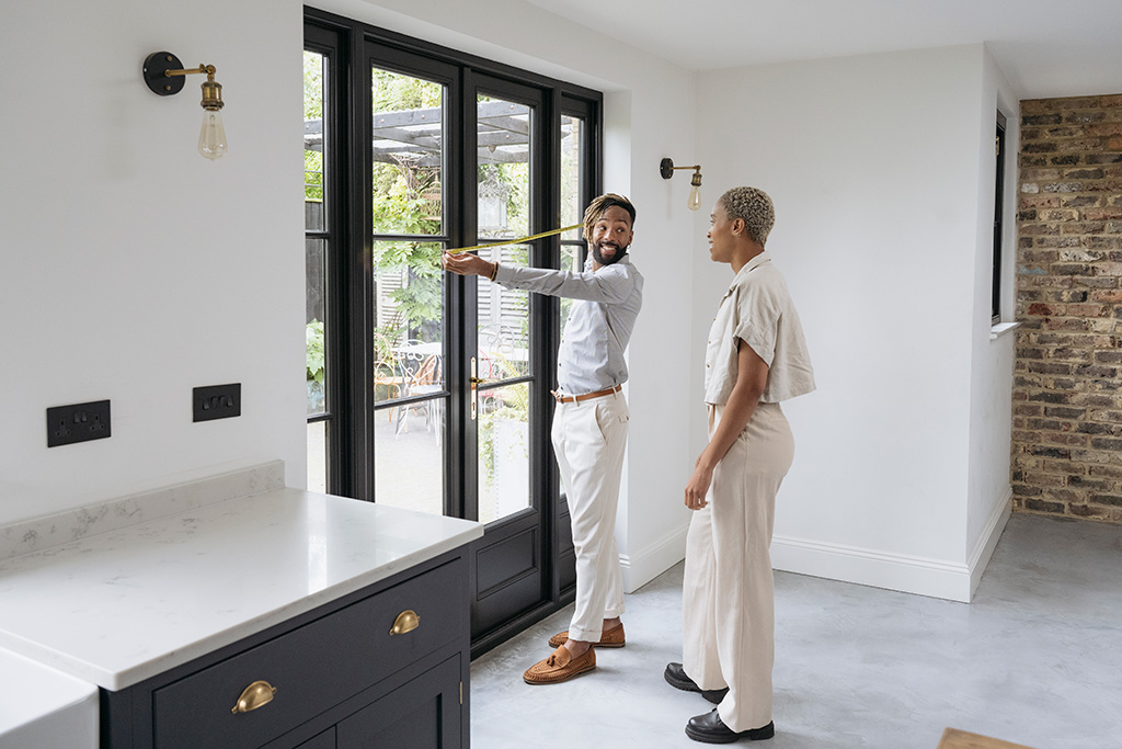 Man and woman measuring door