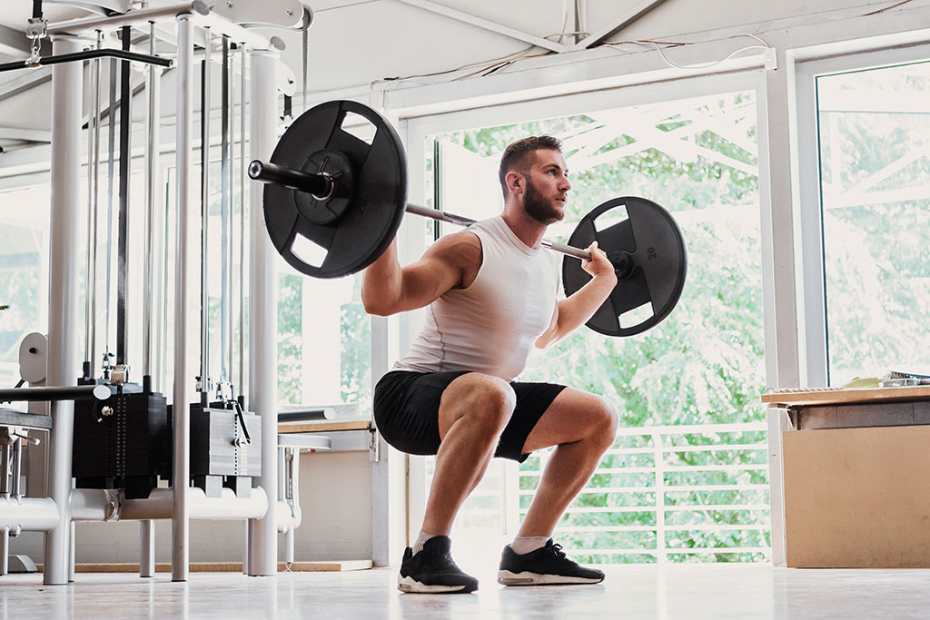 Man squatting weight