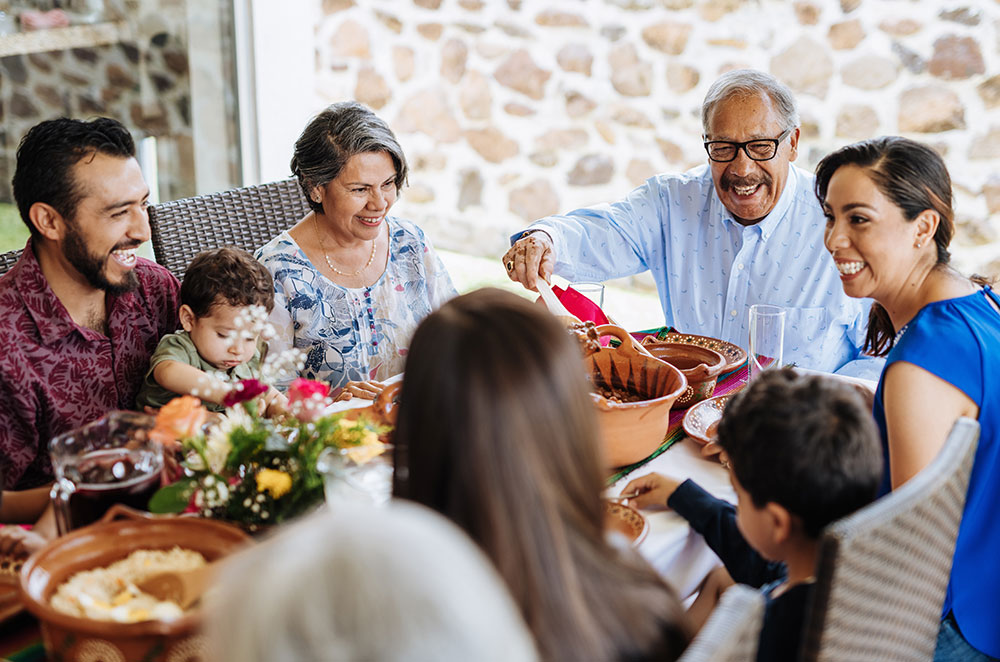 Multi-generational family eating outside