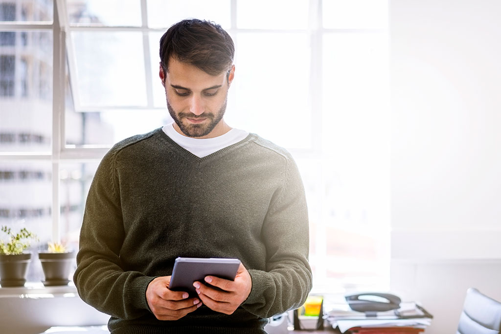 Man looking at tablet