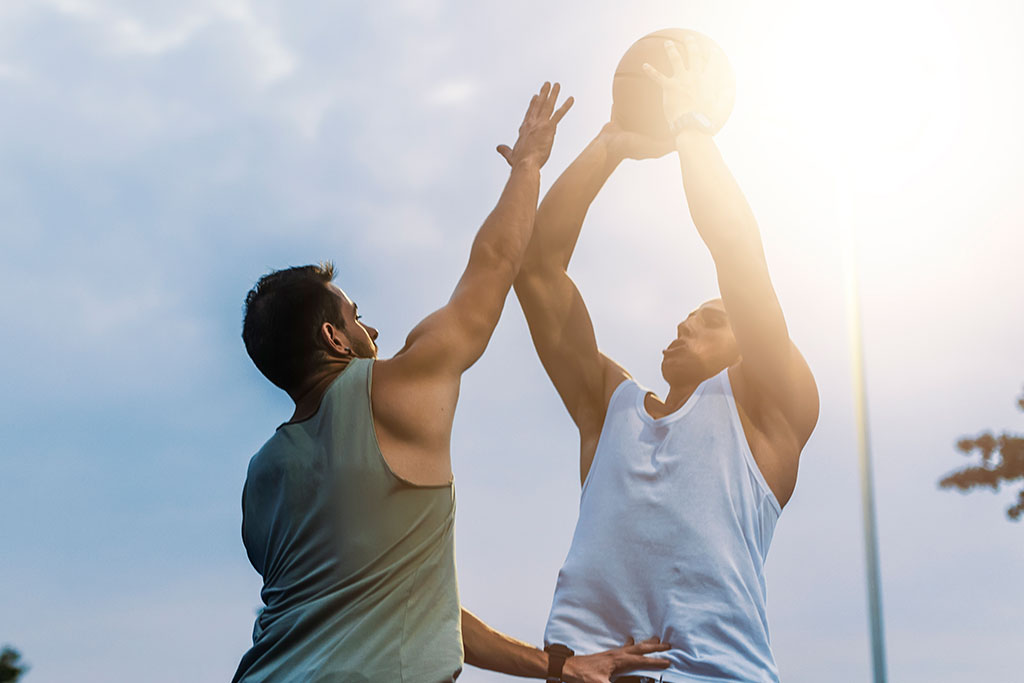 Men playing basketball