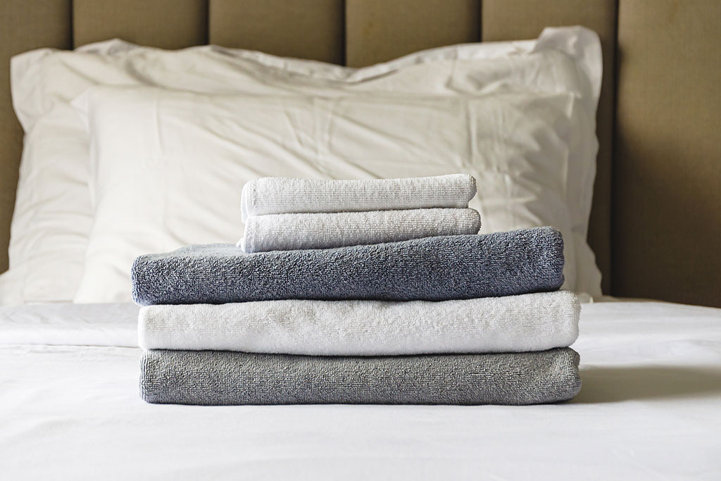 Clean folded towels on bed