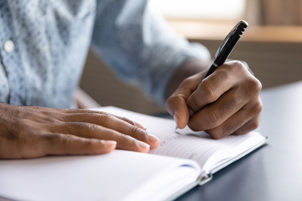 Man writing down notes