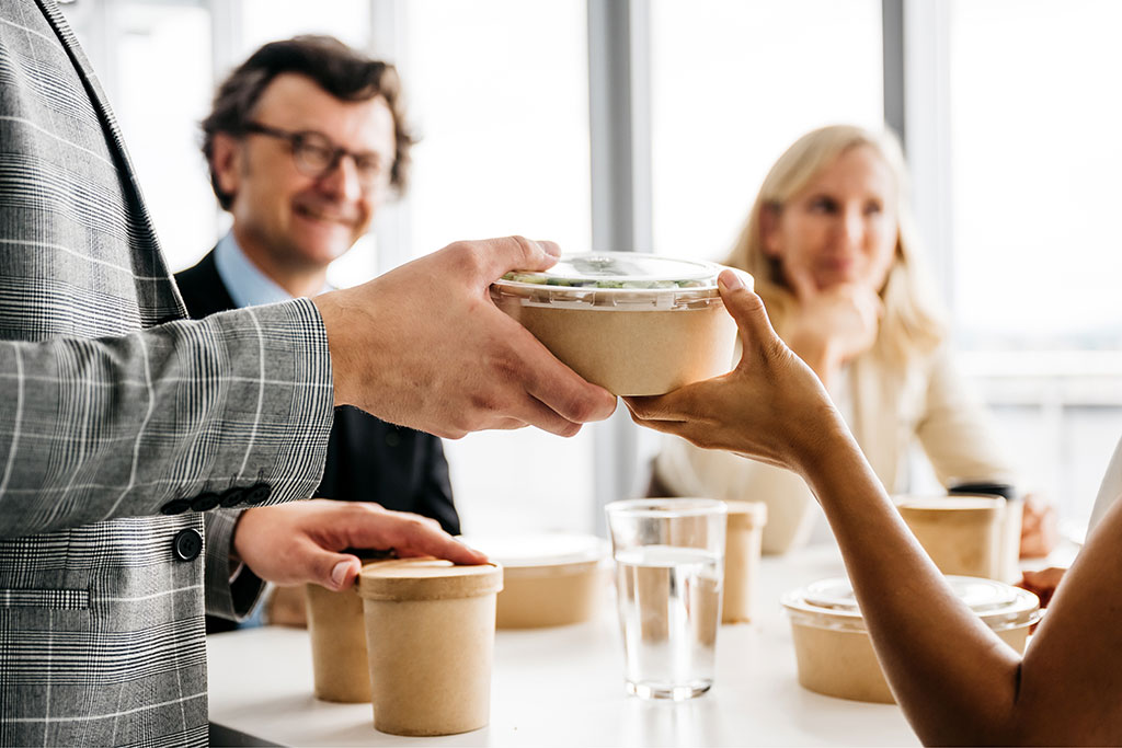 Workers handing out catered food