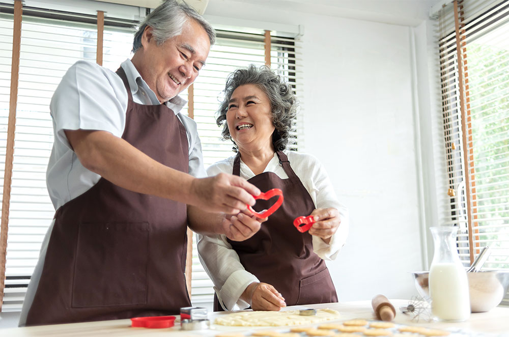 Older couple making valentines cookies