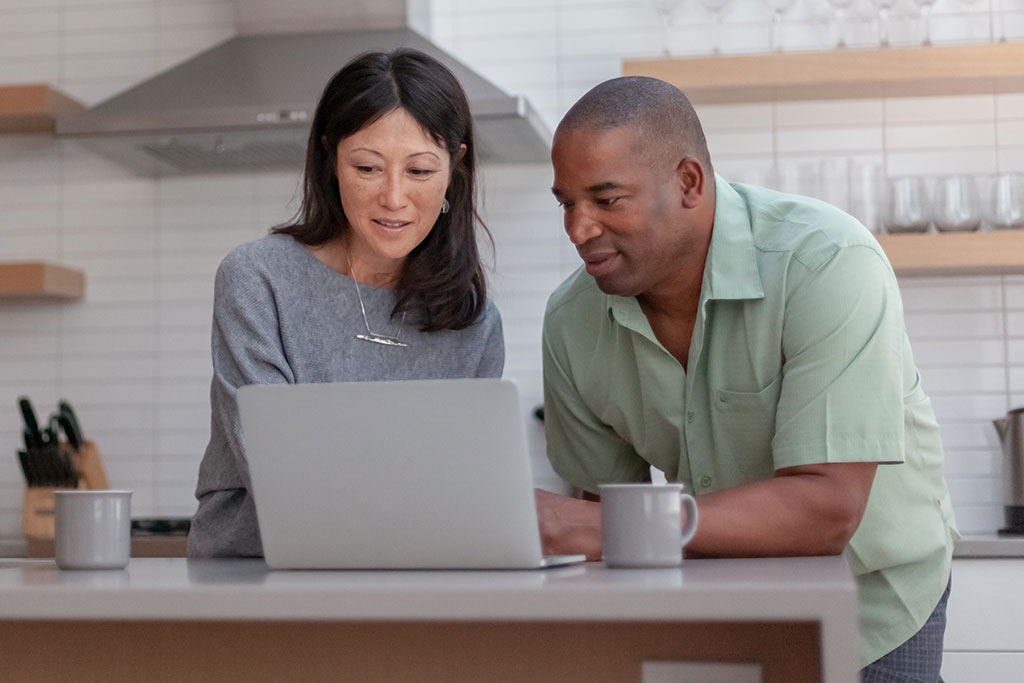 Couple going over finances in kitchen