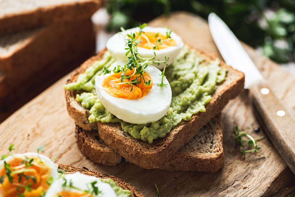Avocado toast with boiled egg on top