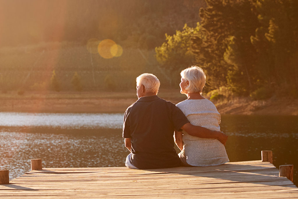 Older couple sitting together on dock