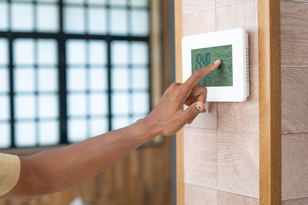 Person setting thermostat