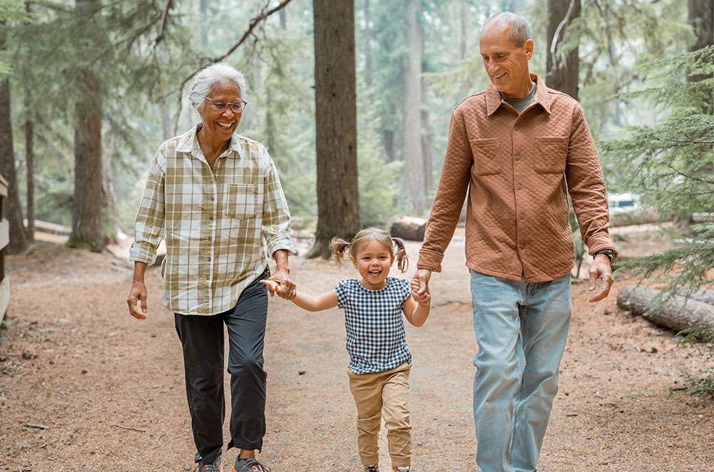 Grandparents walking on trail with granddaughter