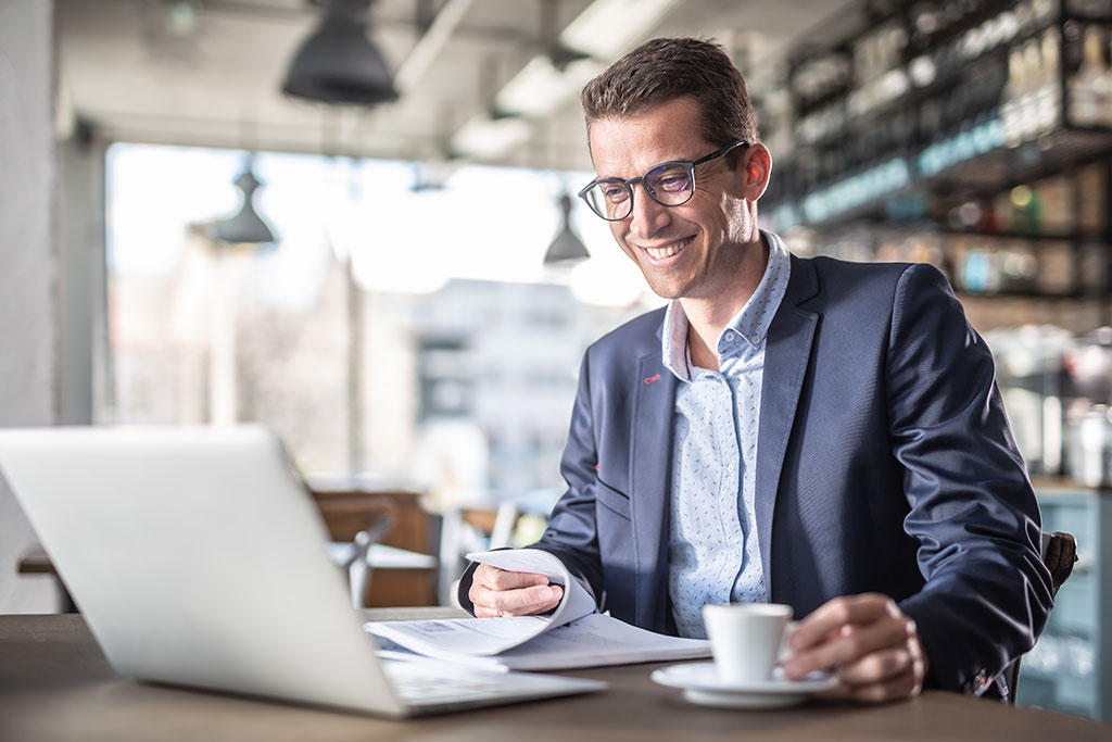 Man using laptop at coffee shop