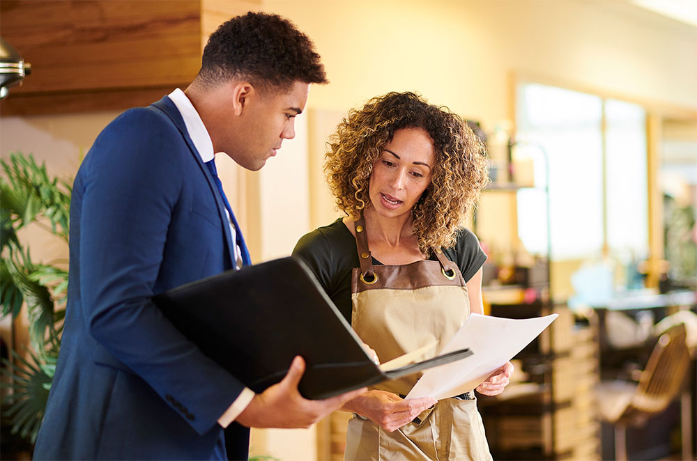 Business owner talking with co-worker