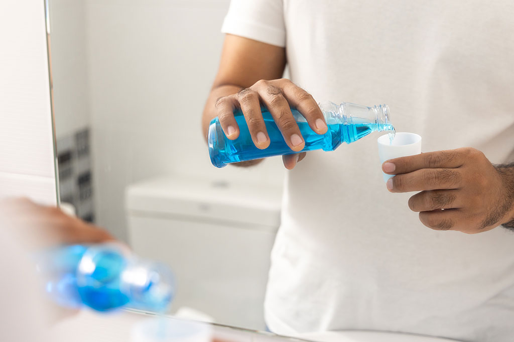 Man pouring mouth wash