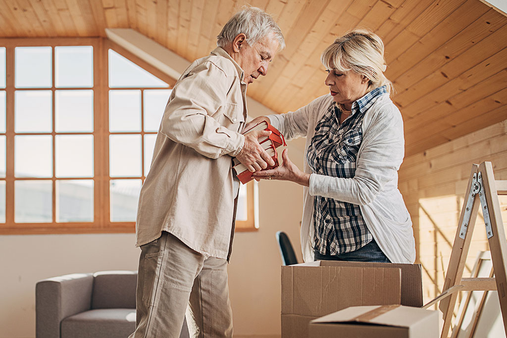 Older couple packing boxes