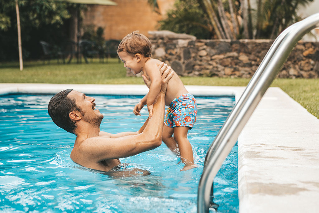 Dad and son playing in pool