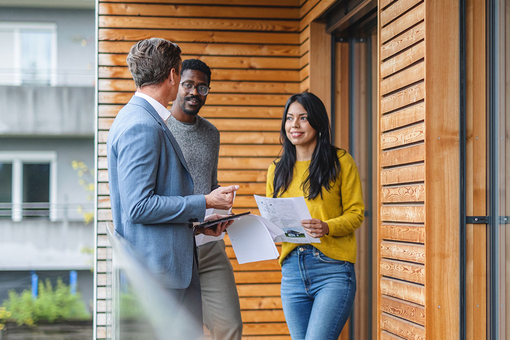 Couple talking with real estate agent