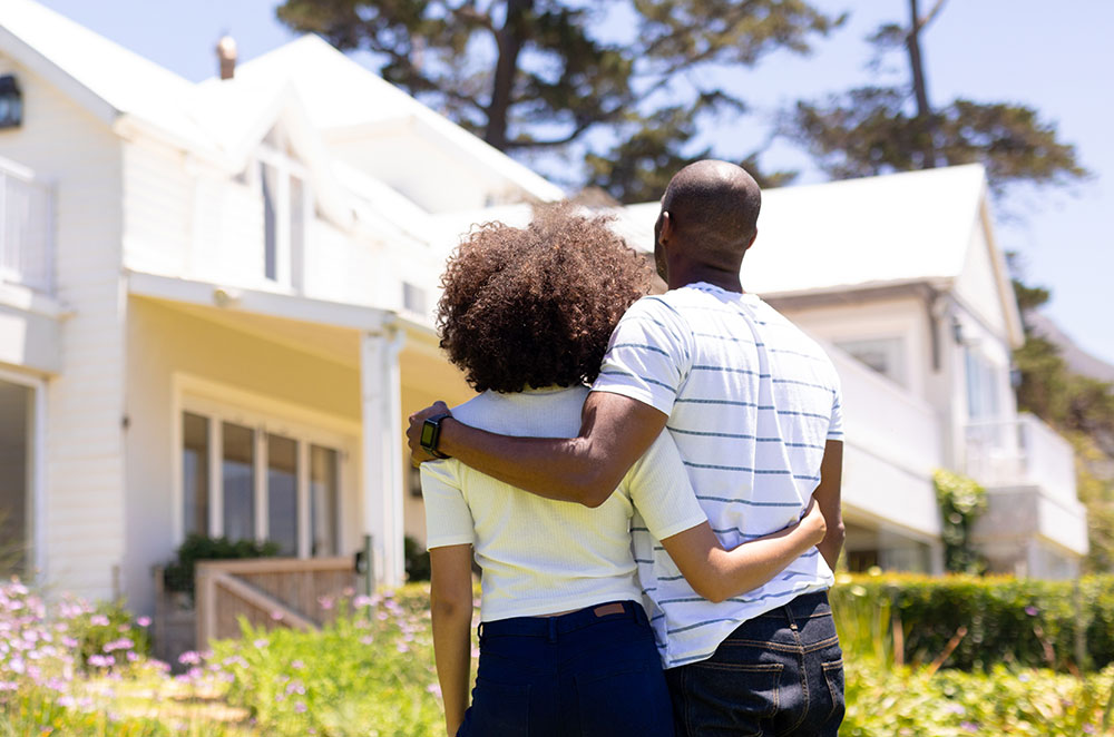 Couple outside looking at house