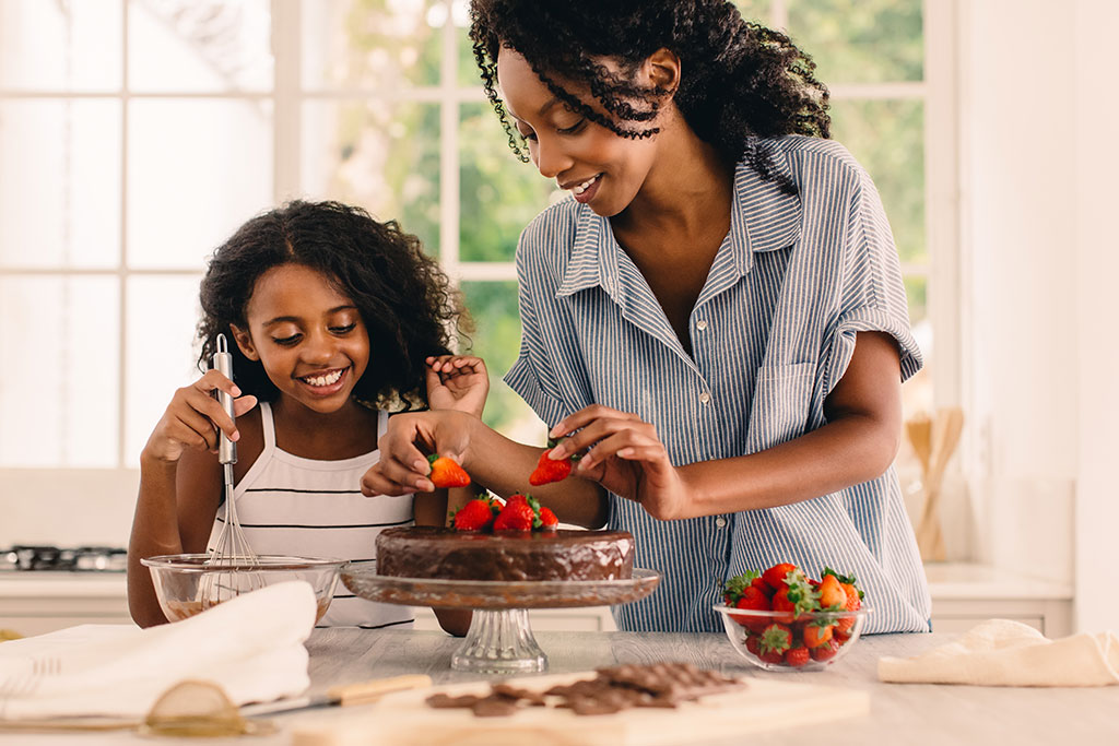 Mom and daughter baking cake