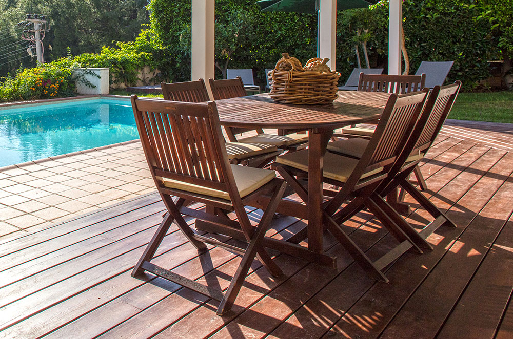 Outdoor table on covered deck by pool