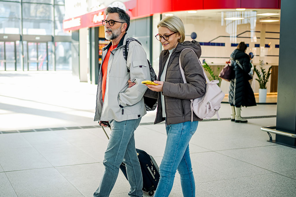 Older couple walking through airport