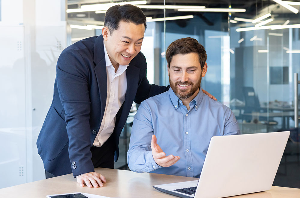 Business men looking at laptop
