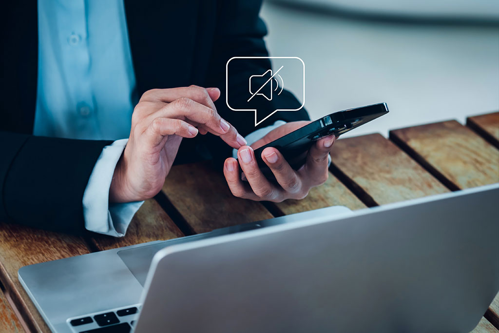 Mute icon above business person's phone
