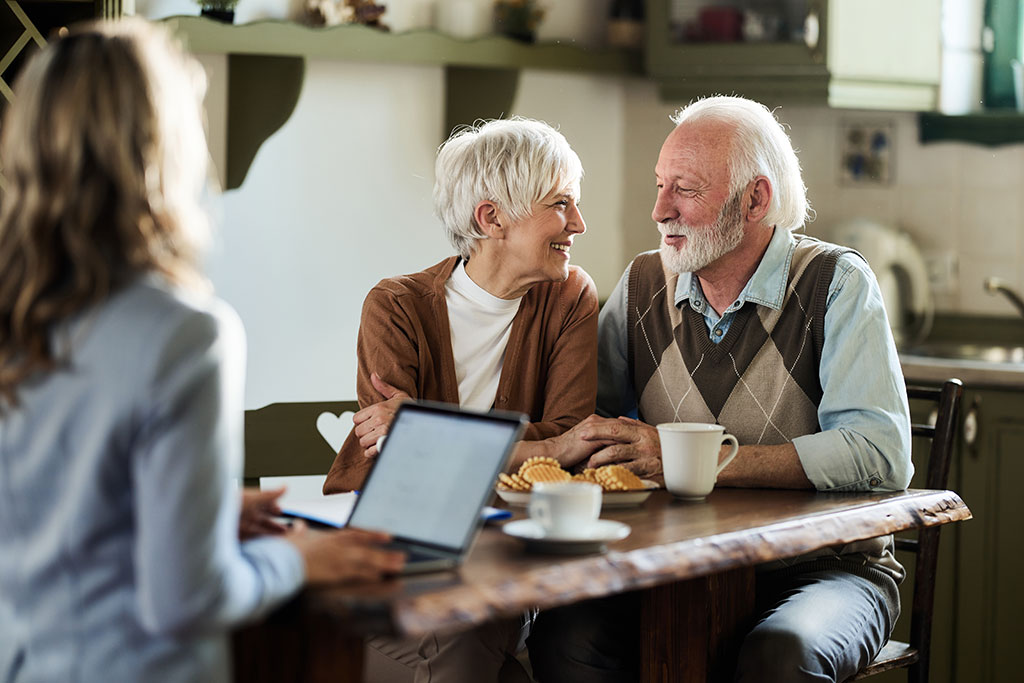 Older couple talking with advisor