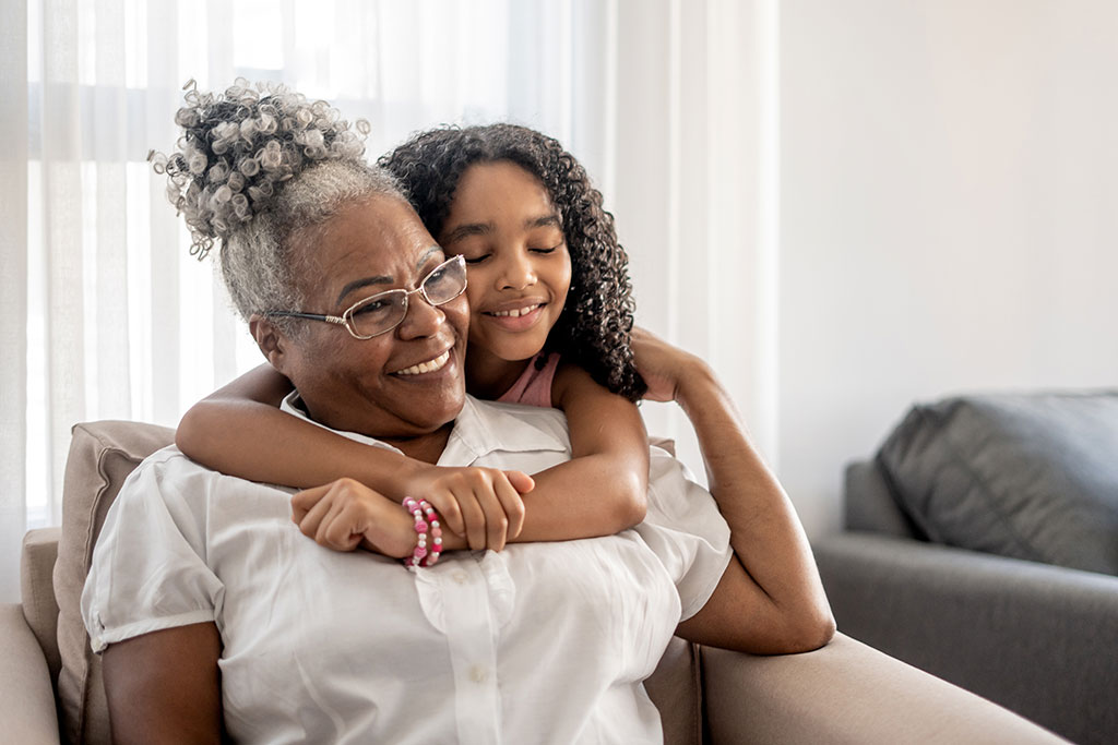 Grandmother and granddaughter hugging