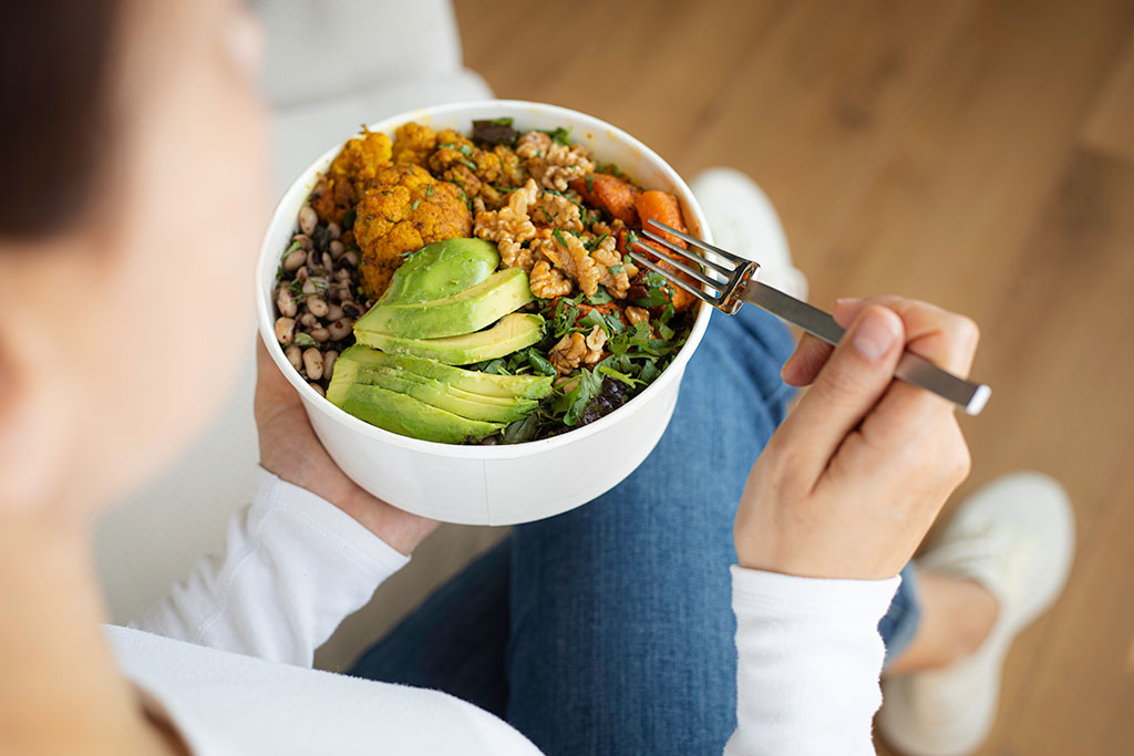 Woman eating healthy bowl