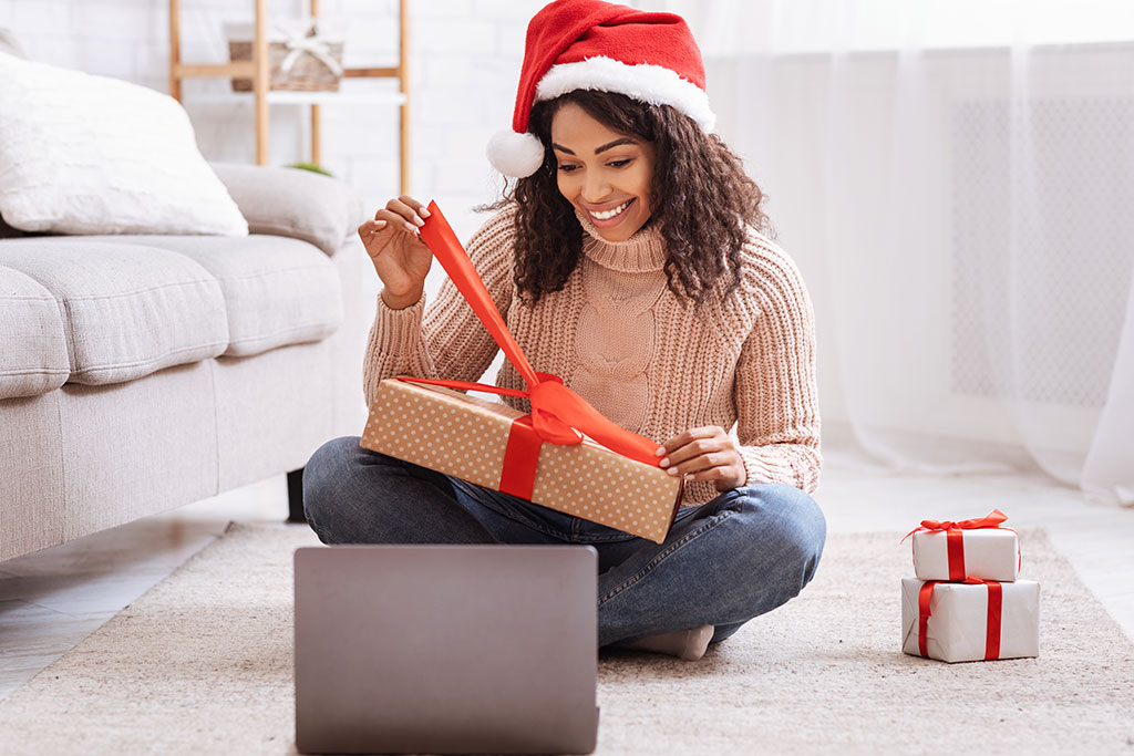 Woman opening gift over video call