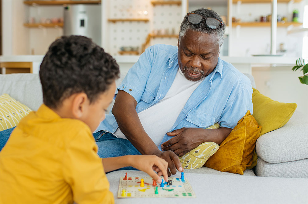 Grandson and grandpa playing board game