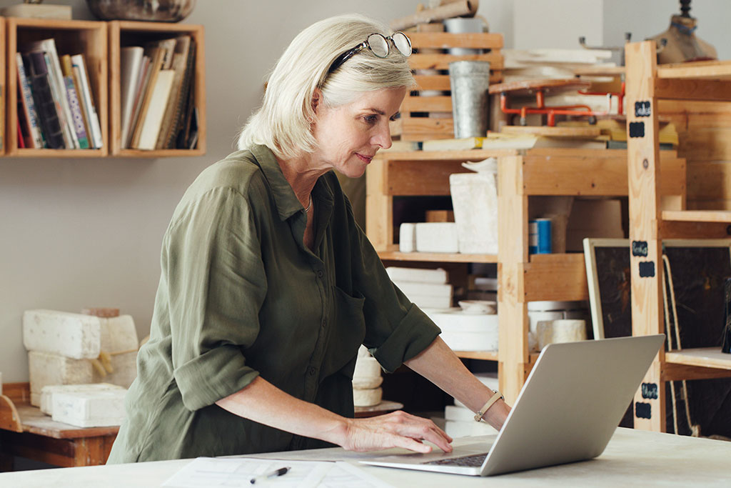 Older business woman using laptop