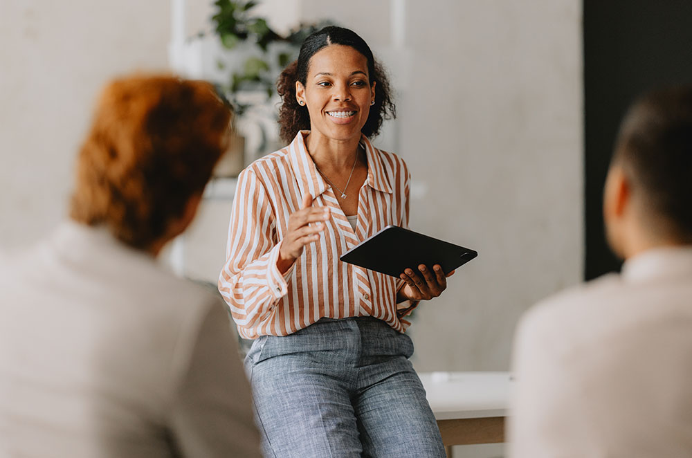 Business woman talking to employees