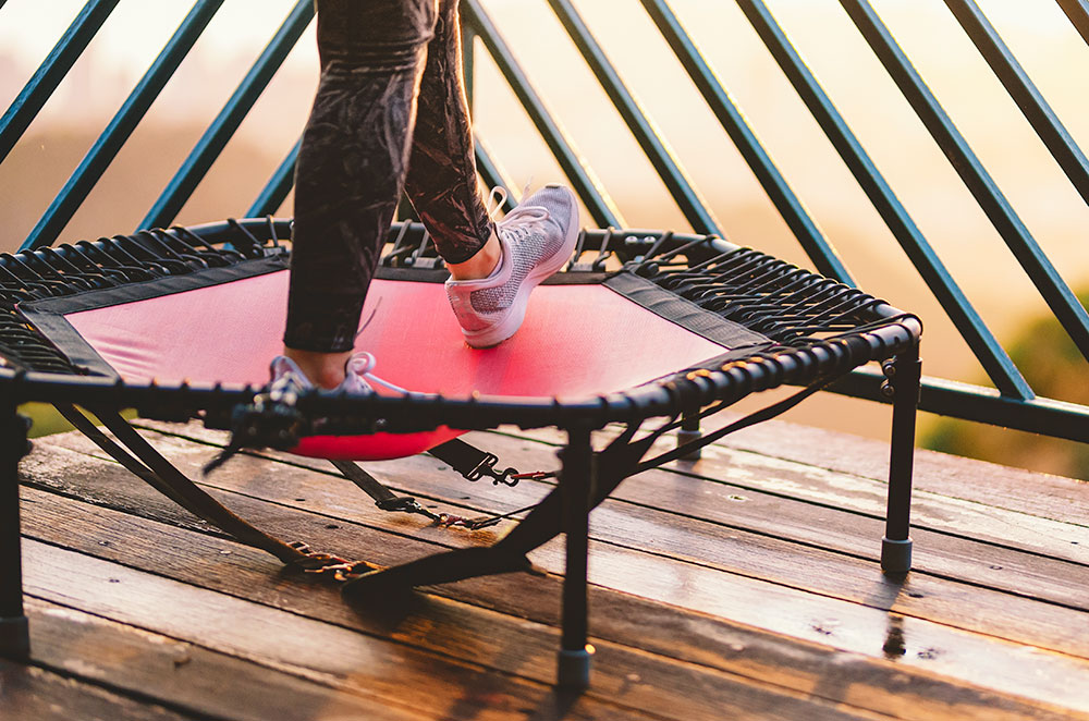 Person exercising on mini trampoline