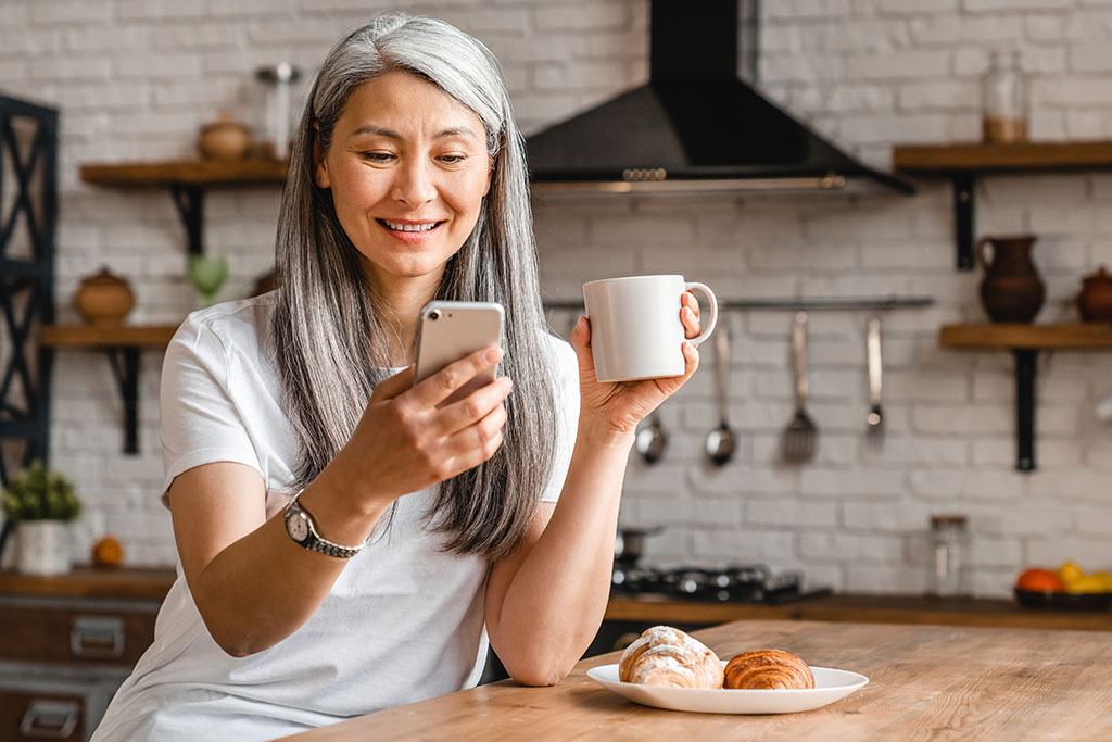 Woman looking at phone smiling