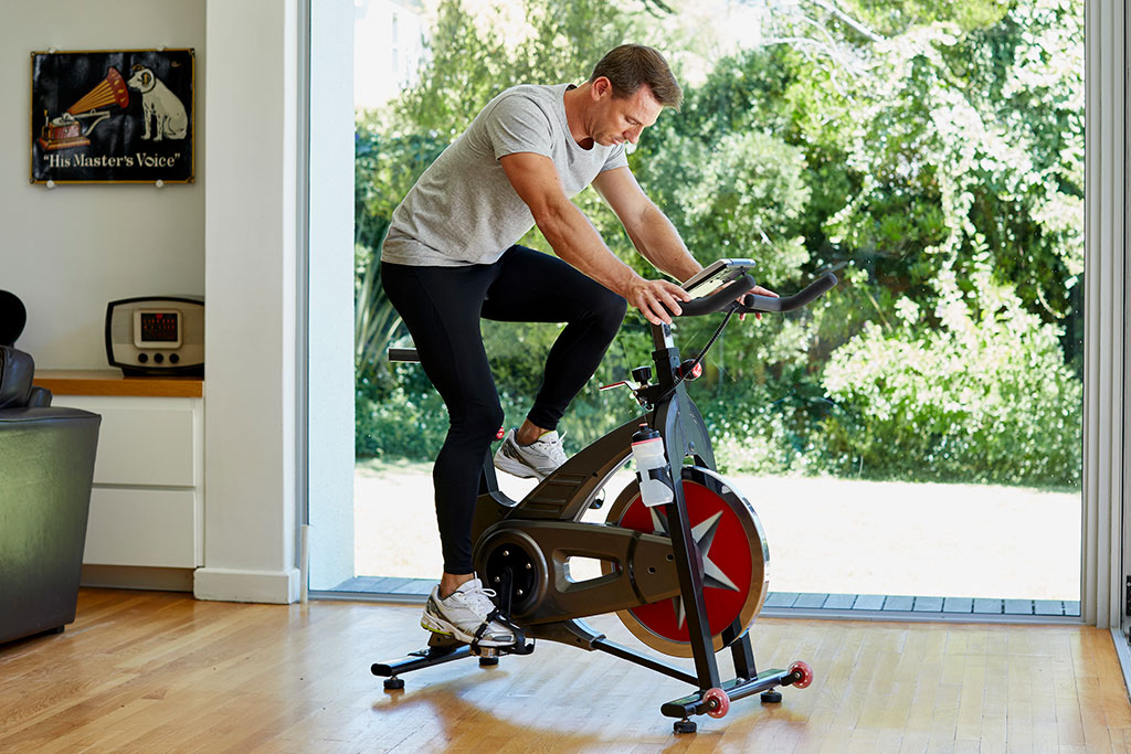 Man riding bike at home