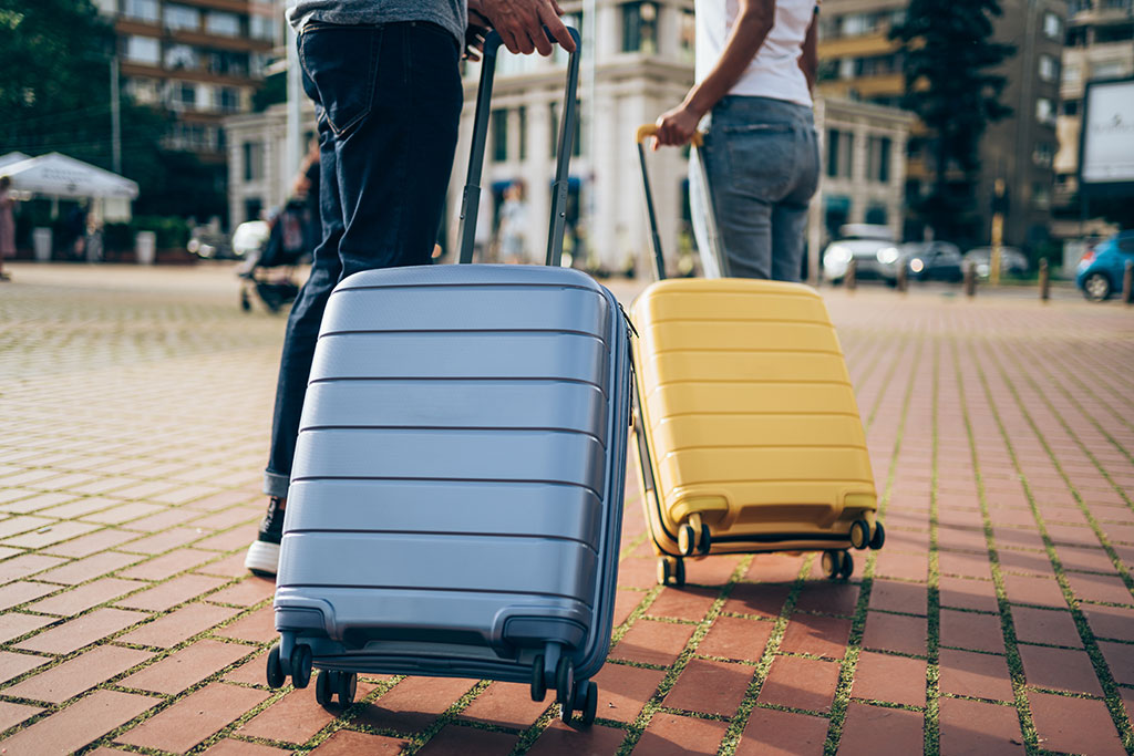 People pulling their suitcase