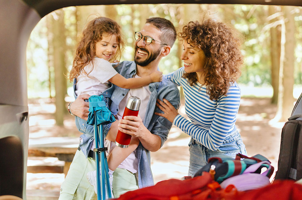 Couple with packed car for road trip