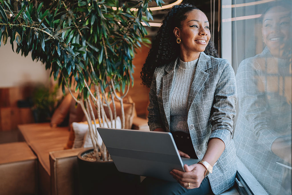 Business woman looking out window happy