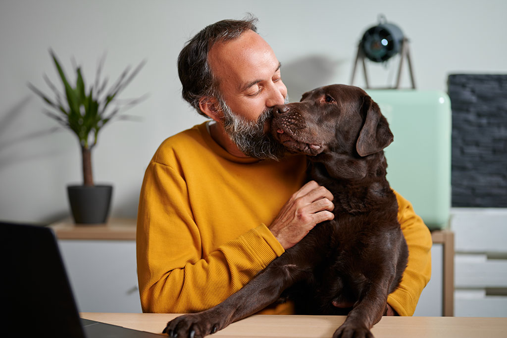 Man hugging dog