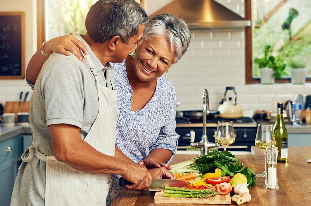 Older couple making cooking in kitchen