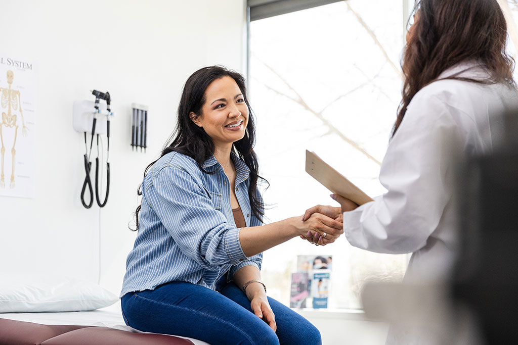 Woman shaking hands with Doctor at appointment