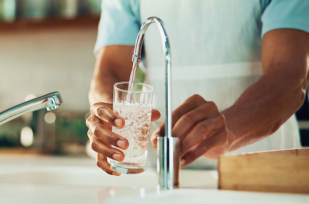 Man getting water from sink