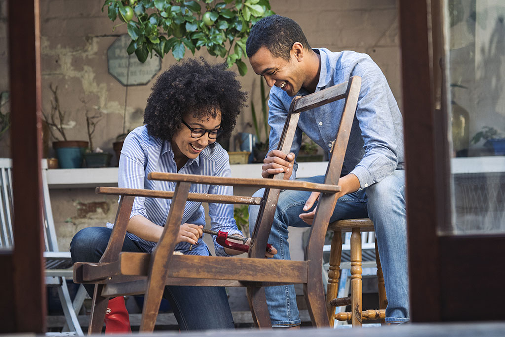 Couple restoring antique chair