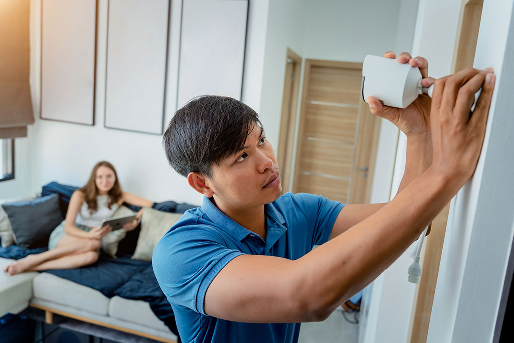 Man setting up camera in home