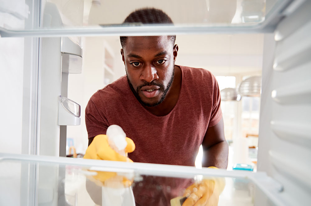 Man cleaning fridge