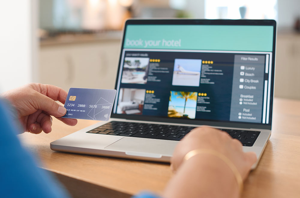 Person looking for a hotel on laptop